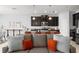 Open-concept living space with kitchen island, ample counter seating, and stainless appliances at 935 Terra Vista St, Brandon, FL 33511