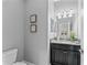 Well-lit powder room featuring a granite countertop, modern fixtures, and wall decor at 935 Terra Vista St, Brandon, FL 33511
