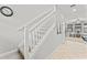 A modern staircase with neutral colors leads to the upper level of the home at 935 Terra Vista St, Brandon, FL 33511