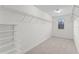 The walk-in closet features carpet, shelving, and a window at 935 Terra Vista St, Brandon, FL 33511