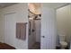 Bathroom featuring a tiled walk-in shower and neutral fixtures at 10118 Cleghorn Dr, San Antonio, FL 33576