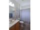 Neutral bathroom with shower, tub, single sink vanity and decorative beach themed art at 10118 Cleghorn Dr, San Antonio, FL 33576