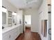 Bathroom featuring a dual vanity sink, decorative mirrors, and walk-in shower at 10118 Cleghorn Dr, San Antonio, FL 33576