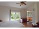 Bedroom with large window and sliding glass door that opens to a covered patio with a hot tub at 10118 Cleghorn Dr, San Antonio, FL 33576