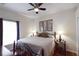 Comfortable bedroom with a ceiling fan, decorative lamps, and art above the headboard at 10118 Cleghorn Dr, San Antonio, FL 33576