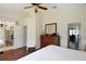 Cozy bedroom with a view to the screened lanai and an open door to an office space at 10118 Cleghorn Dr, San Antonio, FL 33576