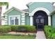 Inviting front entrance with beautiful landscaping and a cozy bench at 10118 Cleghorn Dr, San Antonio, FL 33576