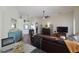 Open living room with hardwood floors, comfortable leather furniture, and natural light at 10118 Cleghorn Dr, San Antonio, FL 33576