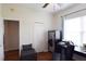Well-lit office space featuring a desk, storage bench, and safe for secure storage at 10118 Cleghorn Dr, San Antonio, FL 33576