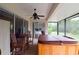 Inviting covered patio featuring a hot tub and wood chairs and table at 10118 Cleghorn Dr, San Antonio, FL 33576