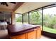 Relaxing sunroom featuring a hot tub and scenic outdoor views at 10118 Cleghorn Dr, San Antonio, FL 33576