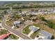 An aerial view captures a residential area with single-Gathering homes, lush greenery, and well-maintained landscaping at 103 El Turco Ct, Sun City Center, FL 33573