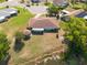 This aerial view highlights the home's backyard pond, well-manicured lawn, and proximity to the community at 103 El Turco Ct, Sun City Center, FL 33573