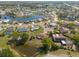 Aerial view of a neighborhood featuring residential homes, a serene lake, and winding roads at 103 El Turco Ct, Sun City Center, FL 33573