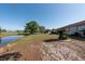 Scenic backyard with a tranquil pond, mature trees, and ample green space, providing a peaceful retreat at 103 El Turco Ct, Sun City Center, FL 33573