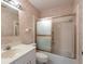 A classic bathroom with a vanity, toilet, and shower/tub combination, all wrapped in vintage-style wallpaper at 103 El Turco Ct, Sun City Center, FL 33573