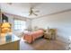 Bright bedroom featuring a ceiling fan, a large window, and comfortable furniture at 103 El Turco Ct, Sun City Center, FL 33573