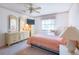 Well-lit bedroom with large dresser, bedside table, and a ceiling fan at 103 El Turco Ct, Sun City Center, FL 33573
