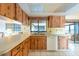 Spacious kitchen with wood cabinets, modern white appliances, and a functional layout for cooking and entertaining at 103 El Turco Ct, Sun City Center, FL 33573