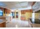 Bright eat-in kitchen featuring wood cabinets, tile floors, white appliances, and plenty of counter space at 103 El Turco Ct, Sun City Center, FL 33573
