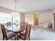 Open concept living and dining area with plush carpet and lots of natural light at 103 El Turco Ct, Sun City Center, FL 33573