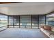 Enclosed sunroom offers plenty of natural light, carpet flooring, and scenic views of the surrounding landscape at 103 El Turco Ct, Sun City Center, FL 33573