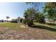 Large yard on a sunny day. Trees and pond in back at 103 El Turco Ct, Sun City Center, FL 33573