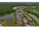 Aerial view of a lovely neighborhood featuring water views, mature landscaping, and a beautiful home at 10734 Breaking Rocks Dr, Tampa, FL 33647