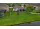 Aerial of a lovely home with a screened patio, lush yard, and access to a serene lake, ideal for outdoor enjoyment at 10734 Breaking Rocks Dr, Tampa, FL 33647