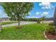 Beautiful backyard featuring lush green grass and a tranquil lake view, creating a serene outdoor space at 10734 Breaking Rocks Dr, Tampa, FL 33647