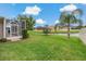 Spacious backyard with a screened lanai, manicured lawn, and scenic water view, perfect for relaxation at 10734 Breaking Rocks Dr, Tampa, FL 33647