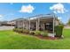 Inviting screened lanai with comfortable seating and a beautifully landscaped yard at 10734 Breaking Rocks Dr, Tampa, FL 33647