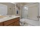 Bathroom boasting modern vanity, enclosed shower-tub combo, and stylish towel hooks at 10734 Breaking Rocks Dr, Tampa, FL 33647