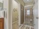 Bathroom featuring a glass enclosed shower with tiled walls and a shower seat at 10734 Breaking Rocks Dr, Tampa, FL 33647