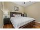 Bedroom features a dark wood bed frame and accents with wood flooring and a ceiling fan at 10734 Breaking Rocks Dr, Tampa, FL 33647