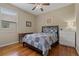 Cozy bedroom with hardwood floors, ceiling fan, window, and coordinated quilt bedding at 10734 Breaking Rocks Dr, Tampa, FL 33647