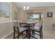 Cozy breakfast nook featuring a modern chandelier and view to the patio at 10734 Breaking Rocks Dr, Tampa, FL 33647