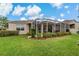 Exterior view of home featuring a screened lanai and landscaping at 10734 Breaking Rocks Dr, Tampa, FL 33647