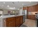 Open kitchen view showcasing the island, stainless steel appliances, and plenty of cabinet space at 10734 Breaking Rocks Dr, Tampa, FL 33647
