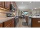 Modern kitchen with stainless steel appliances, quartz countertops, and eat in dining area at 10734 Breaking Rocks Dr, Tampa, FL 33647