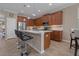 Kitchen island with barstool seating, stainless steel appliances, and gorgeous wood cabinets at 10734 Breaking Rocks Dr, Tampa, FL 33647