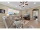 Bright and airy living room with a comfortable seating arrangement and view to Primary Bedroom at 10734 Breaking Rocks Dr, Tampa, FL 33647