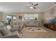 Spacious living room with neutral-toned furnishings, large windows, and access to the patio at 10734 Breaking Rocks Dr, Tampa, FL 33647