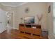 Living room showcasing hardwood floors, console, decor, and bright natural light at 10734 Breaking Rocks Dr, Tampa, FL 33647