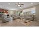 Open living room with neutral tones, a ceiling fan, and modern furnishings at 10734 Breaking Rocks Dr, Tampa, FL 33647