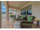 Inviting covered patio featuring comfortable wicker furniture and a brick-paved floor, perfect for outdoor entertaining at 10734 Breaking Rocks Dr, Tampa, FL 33647