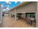 Expansive covered patio with roll-down shades, a dining set, and a screened lanai, offering privacy and space at 10734 Breaking Rocks Dr, Tampa, FL 33647