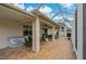 Covered patio with roll-down shades, a screened lanai, and a dining set, providing an inviting and private space at 10734 Breaking Rocks Dr, Tampa, FL 33647
