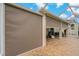 Covered patio with privacy shades, brick-paved flooring, and a screened lanai offers a versatile outdoor living space at 10734 Breaking Rocks Dr, Tampa, FL 33647