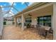 Spacious screened patio with neutral brick flooring and comfortable seating at 10734 Breaking Rocks Dr, Tampa, FL 33647